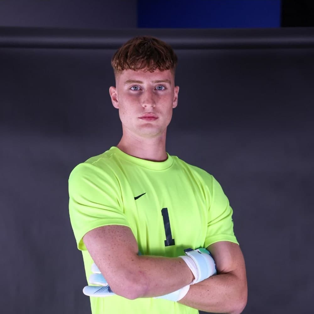 Fabio Jäger – Westcliff University, NAIA Headshot of a young male college soccer goalkeeper in a neon jersey.